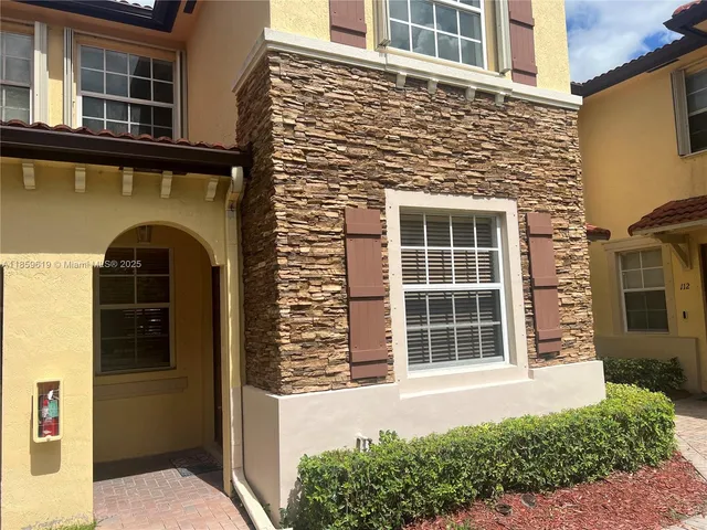 front view of a brick house with a large window
