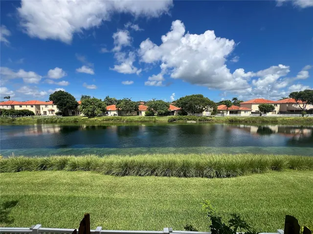 a view of a lake with houses in the background
