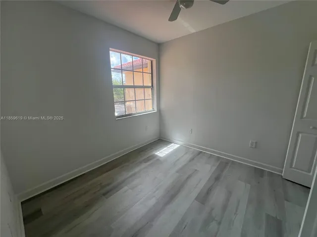 an empty room with a empty space and windows