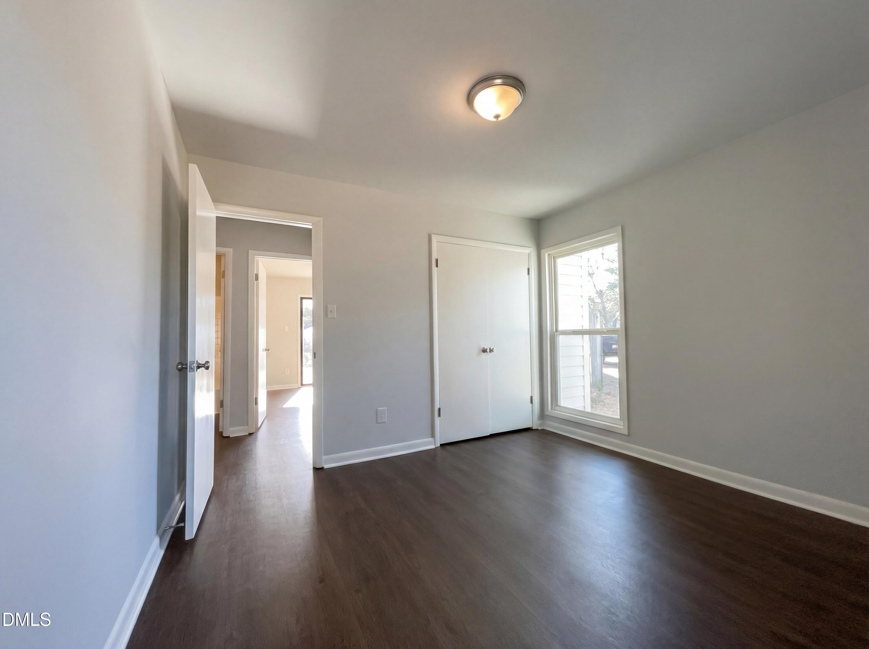 4113 Mill Bridge Road Hope Mills, NC 28348 - Photo 11 of 18 an empty room with wooden floor and windows
