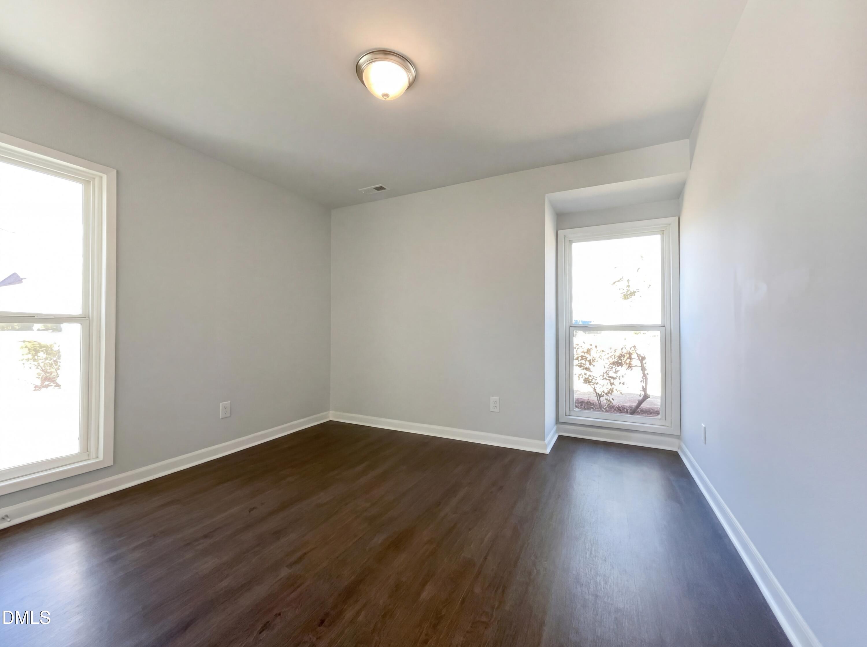 4113 Mill Bridge Road Hope Mills, NC 28348 - Photo 15 of 18 an empty room with wooden floor and windows