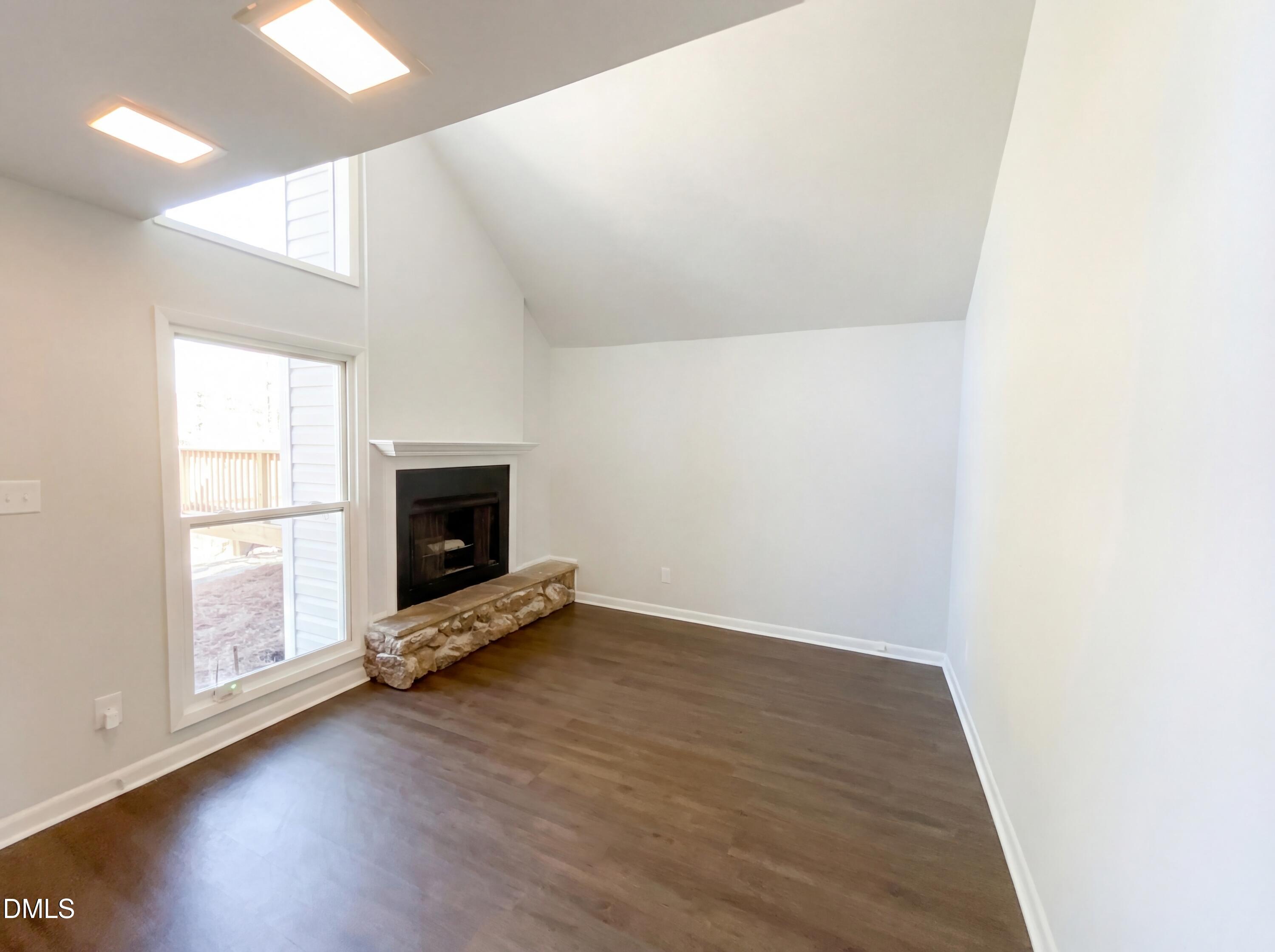 4113 Mill Bridge Road Hope Mills, NC 28348 - Photo 3 of 18 an empty room with wooden floor and fireplace
