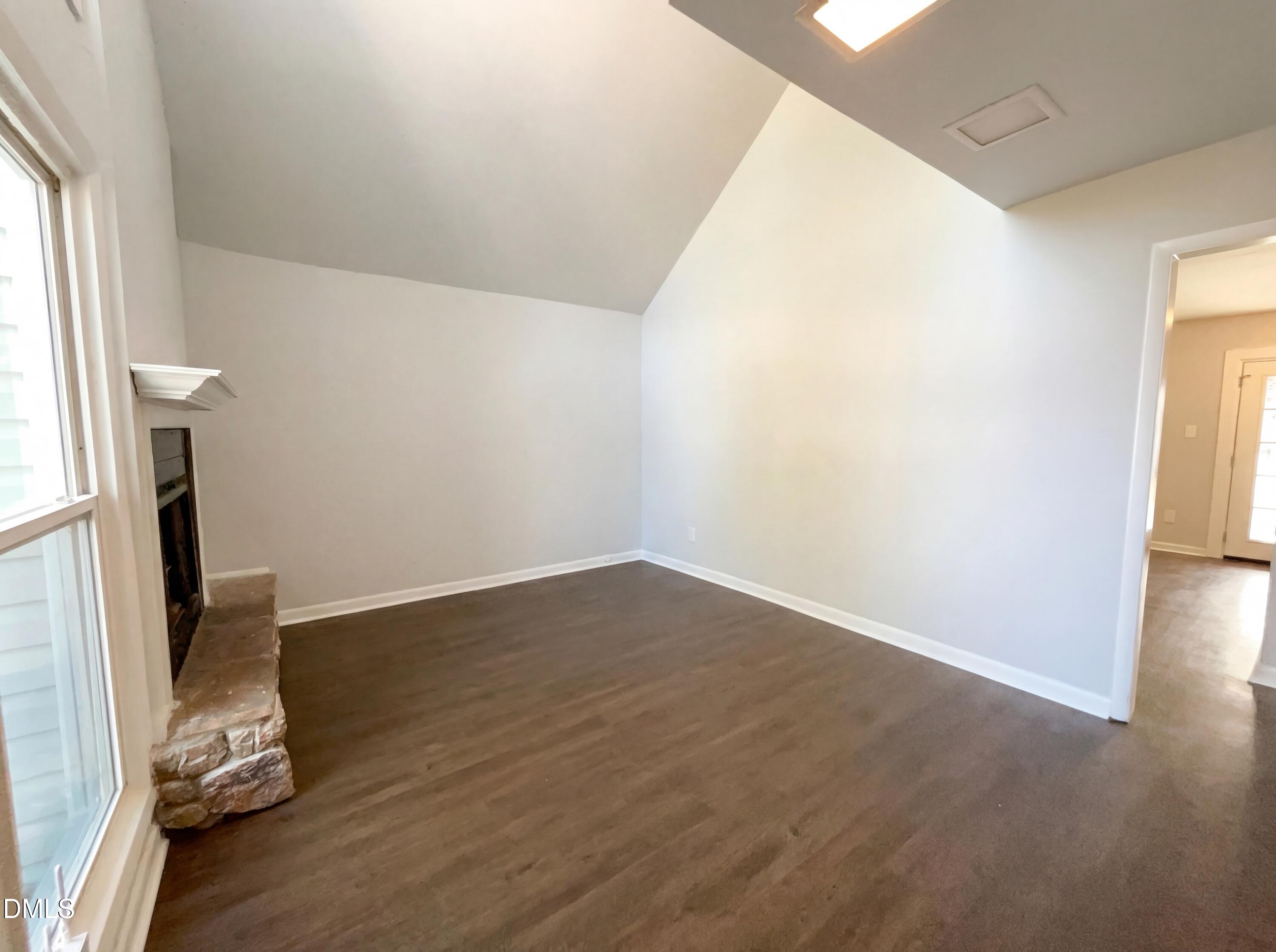 4113 Mill Bridge Road Hope Mills, NC 28348 - Photo 4 of 18 an empty room with wooden floor and a window