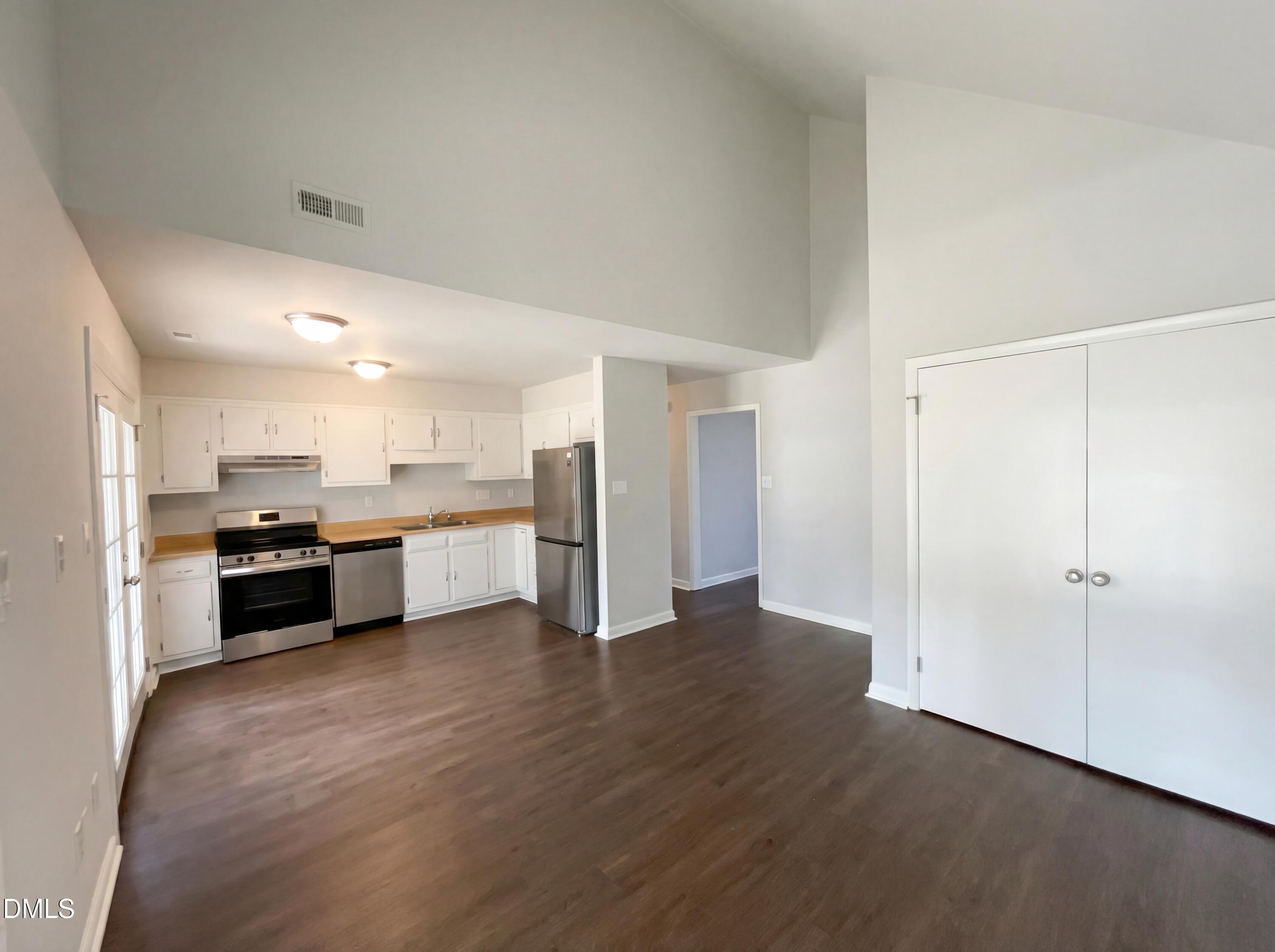 4113 Mill Bridge Road Hope Mills, NC 28348 - Photo 7 of 18 a large open kitchen with a refrigerator and a stove top oven