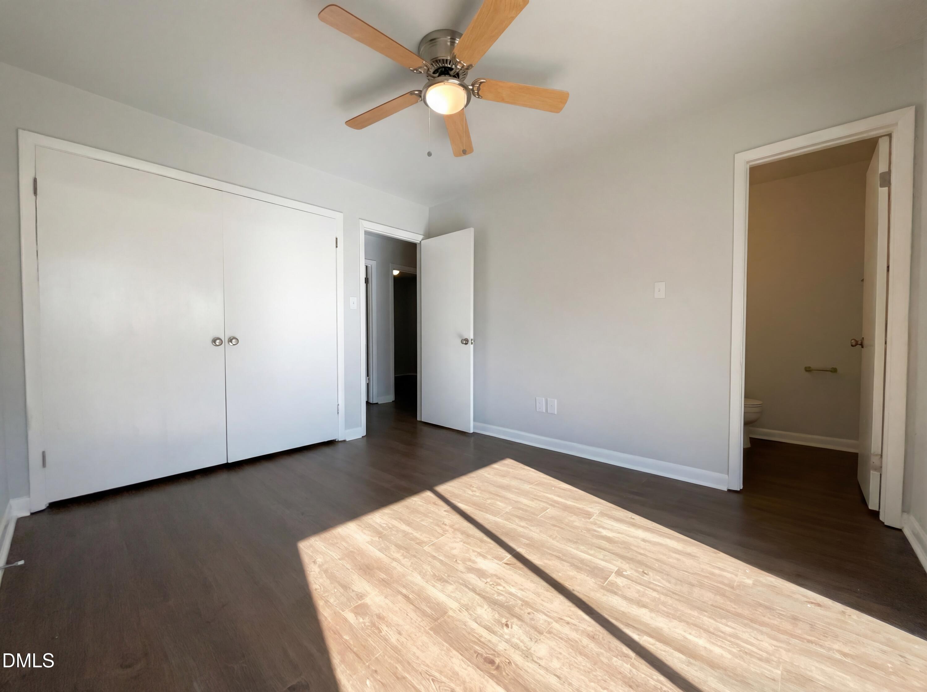 4113 Mill Bridge Road Hope Mills, NC 28348 - Photo 8 of 18 a view of a room with wooden floor and a ceiling fan