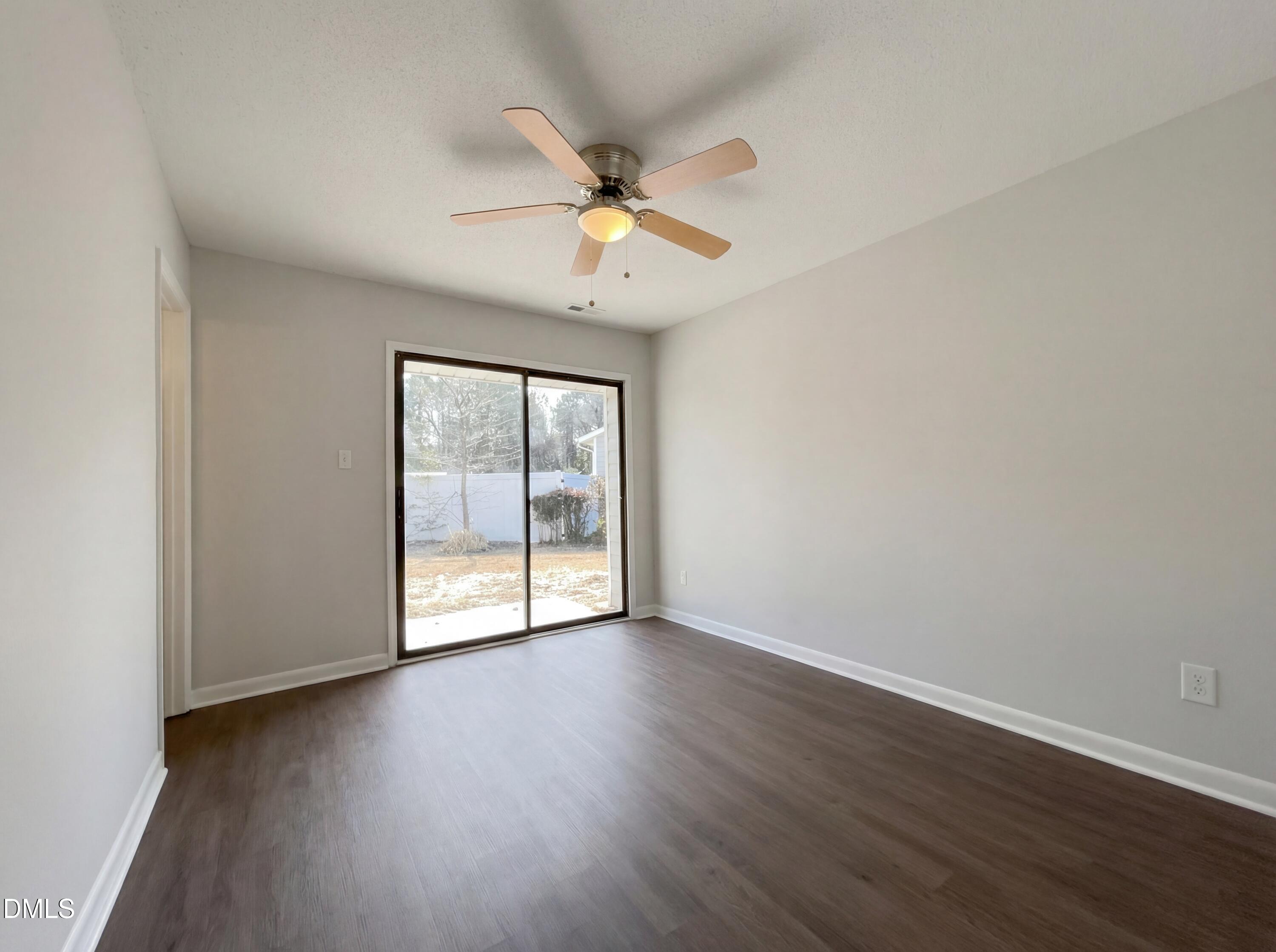 4113 Mill Bridge Road Hope Mills, NC 28348 - Photo 10 of 18 an empty room with wooden floor fan and windows