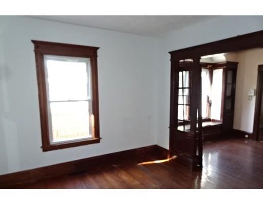 126 Jasper Street Springfield, MA 01109 - Photo 3 of 14 an empty room with wooden floor and windows