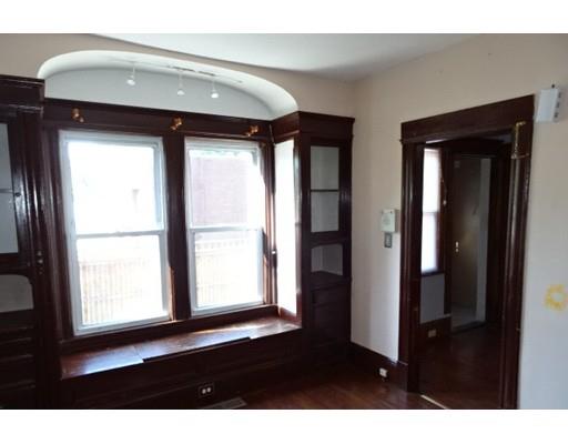 126 Jasper Street Springfield, MA 01109 - Photo 5 of 14 a view of an empty room with wooden floor and a window