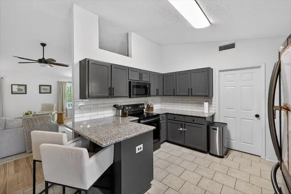 a kitchen that has a sink and chair in it
