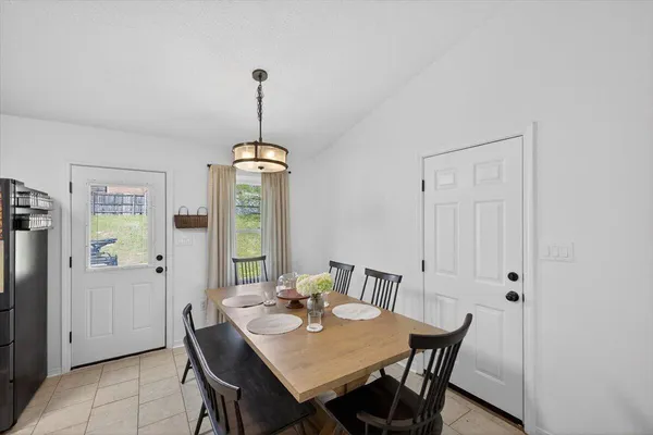 a view of a dining room with furniture wooden floor and chandelier