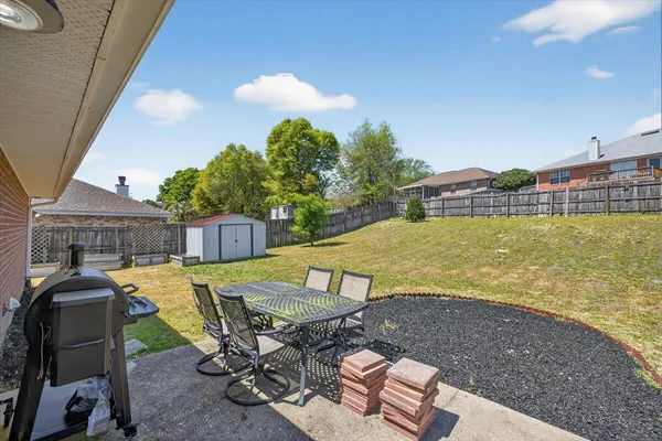 a bedroom with a bed dresser and a window