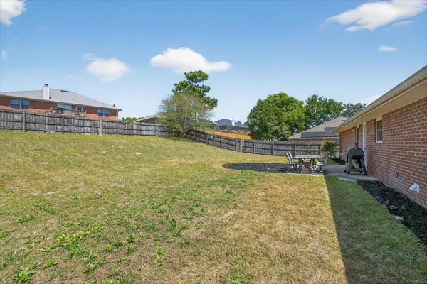a view of a house with swimming pool and a yard