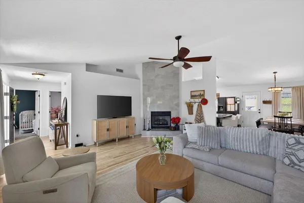 a living room with furniture and a wooden floor