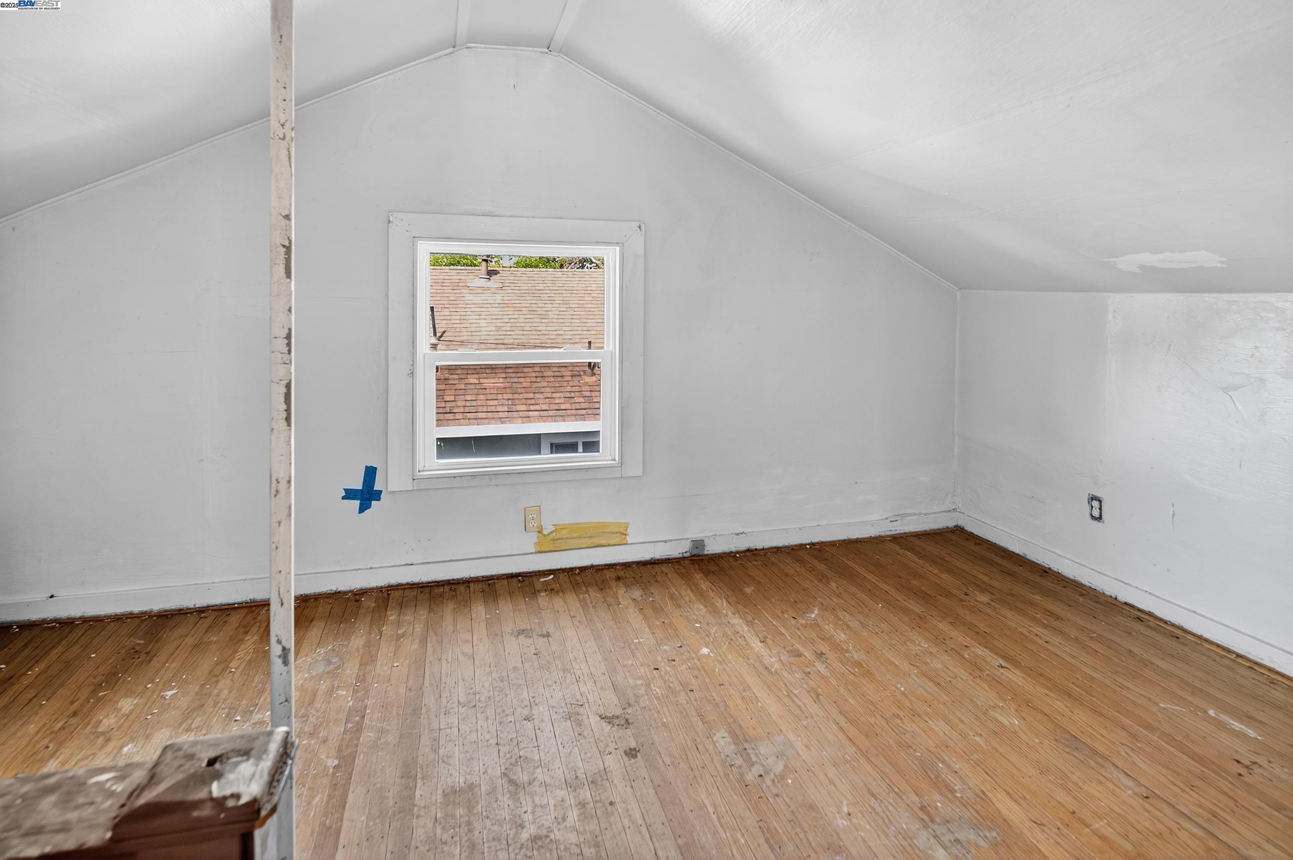 7412 Weld Street Oakland, CA 94621 - Photo 15 of 19 an empty room with wooden floor and windows