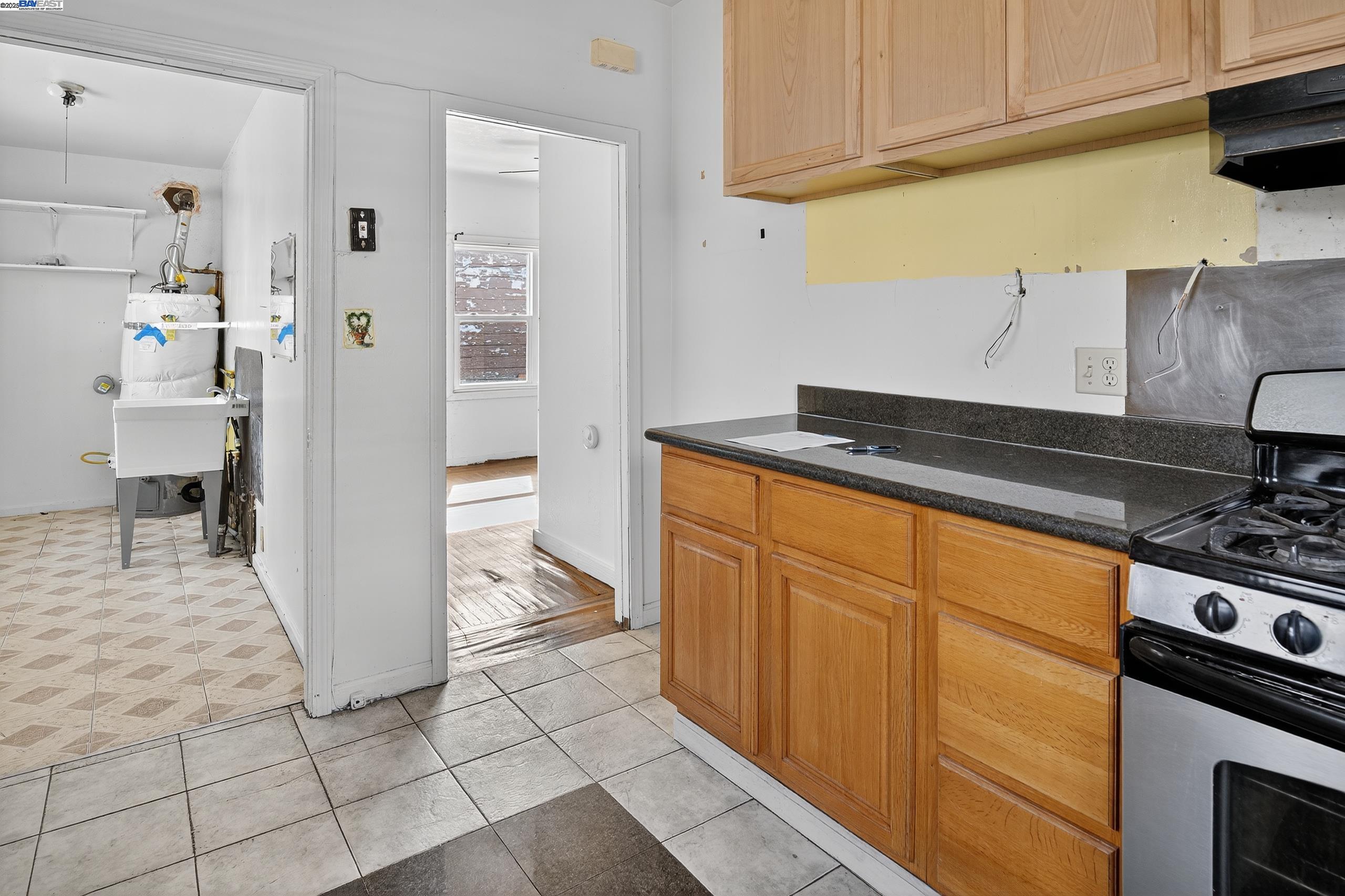 7412 Weld Street Oakland, CA 94621 - Photo 7 of 19 a kitchen with stainless steel appliances granite countertop a refrigerator and a stove