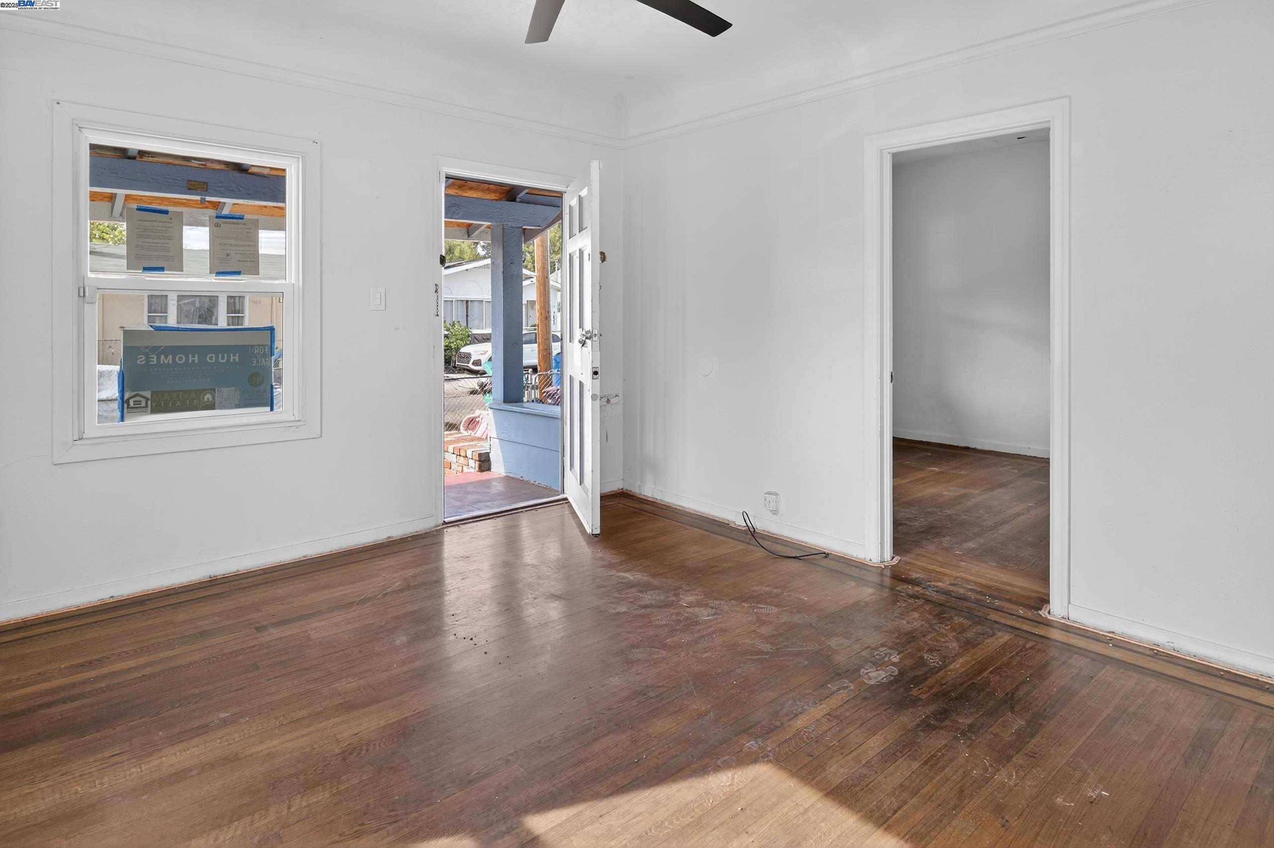 7412 Weld Street Oakland, CA 94621 - Photo 9 of 19 an empty room with wooden floor and a window