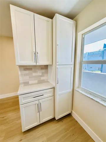 a kitchen with a refrigerator sink and cabinets