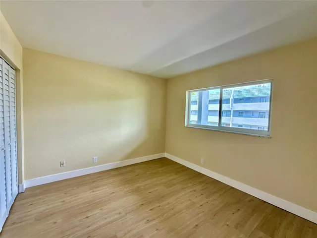 a view of a room with wooden floor and fence