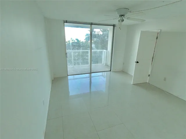 a view of a room with sliding glass door and shower