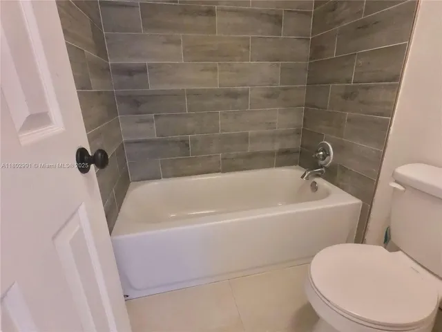 a white bath tub sitting next to a white toilet