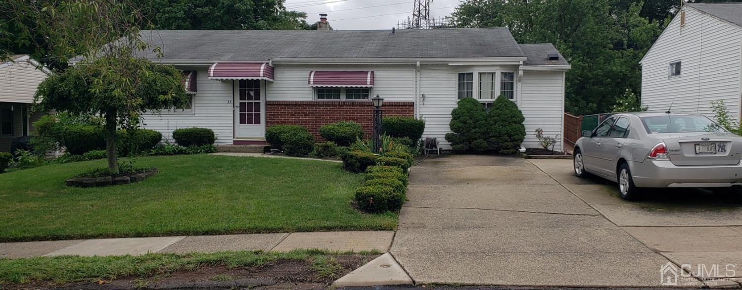 33 Tunison Road New Brunswick, NJ 08901 - Photo 1 of 27 a front view of a house with a garden and plants