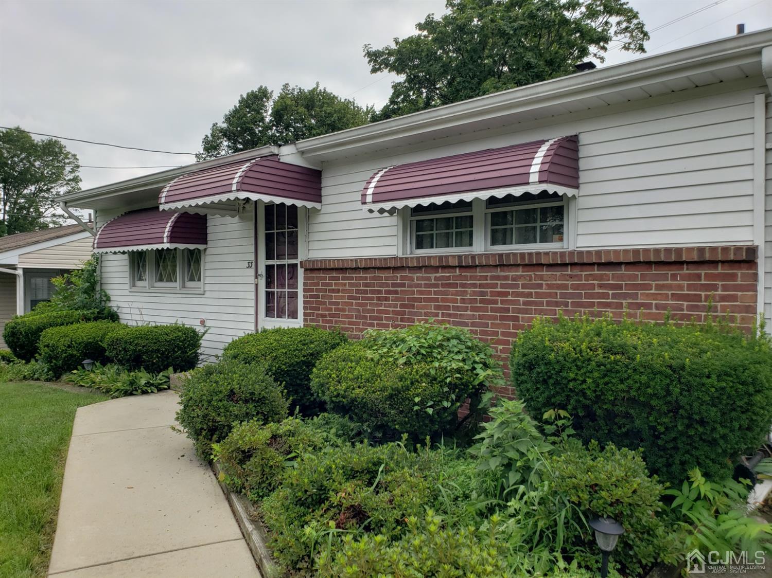 33 Tunison Road New Brunswick, NJ 08901 - Photo 2 of 27 a front view of a house with a yard
