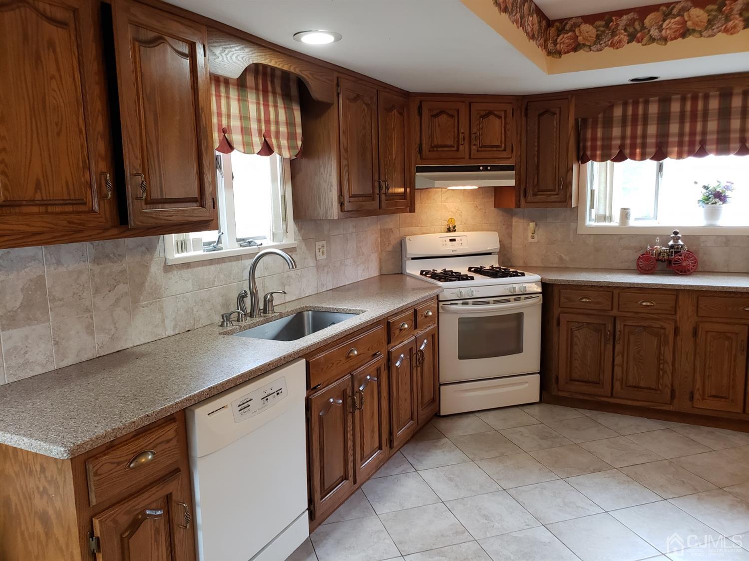 33 Tunison Road New Brunswick, NJ 08901 - Photo 3 of 27 a kitchen with a sink stove and cabinets