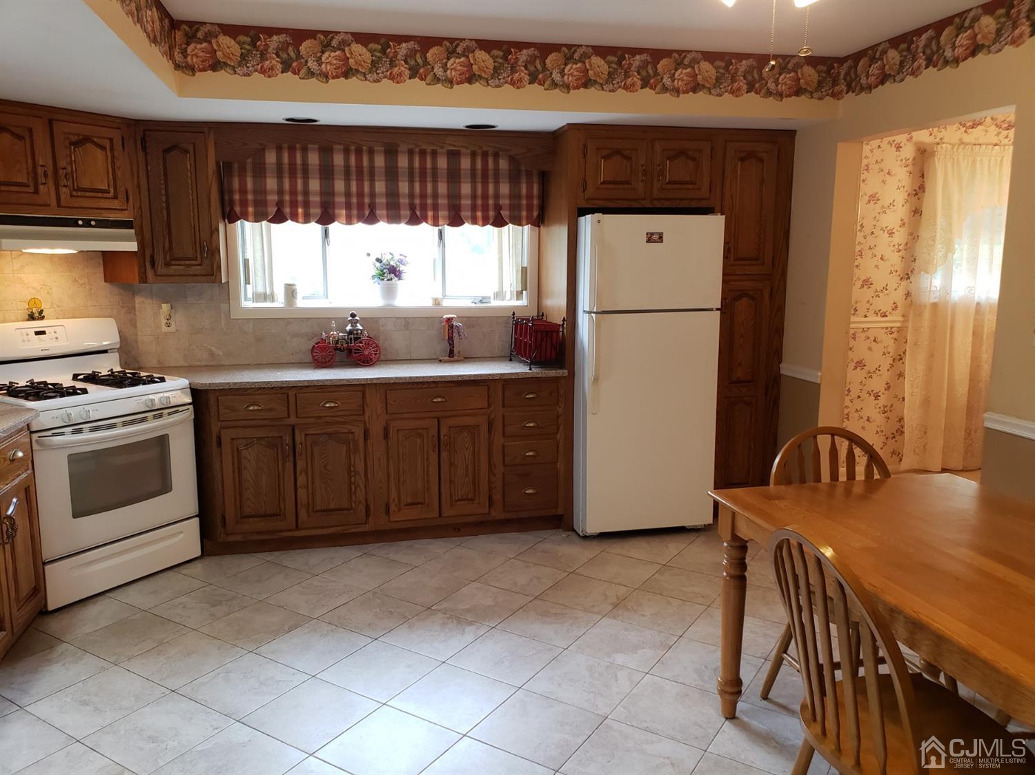 33 Tunison Road New Brunswick, NJ 08901 - Photo 4 of 27 a kitchen with a stove a refrigerator and a sink