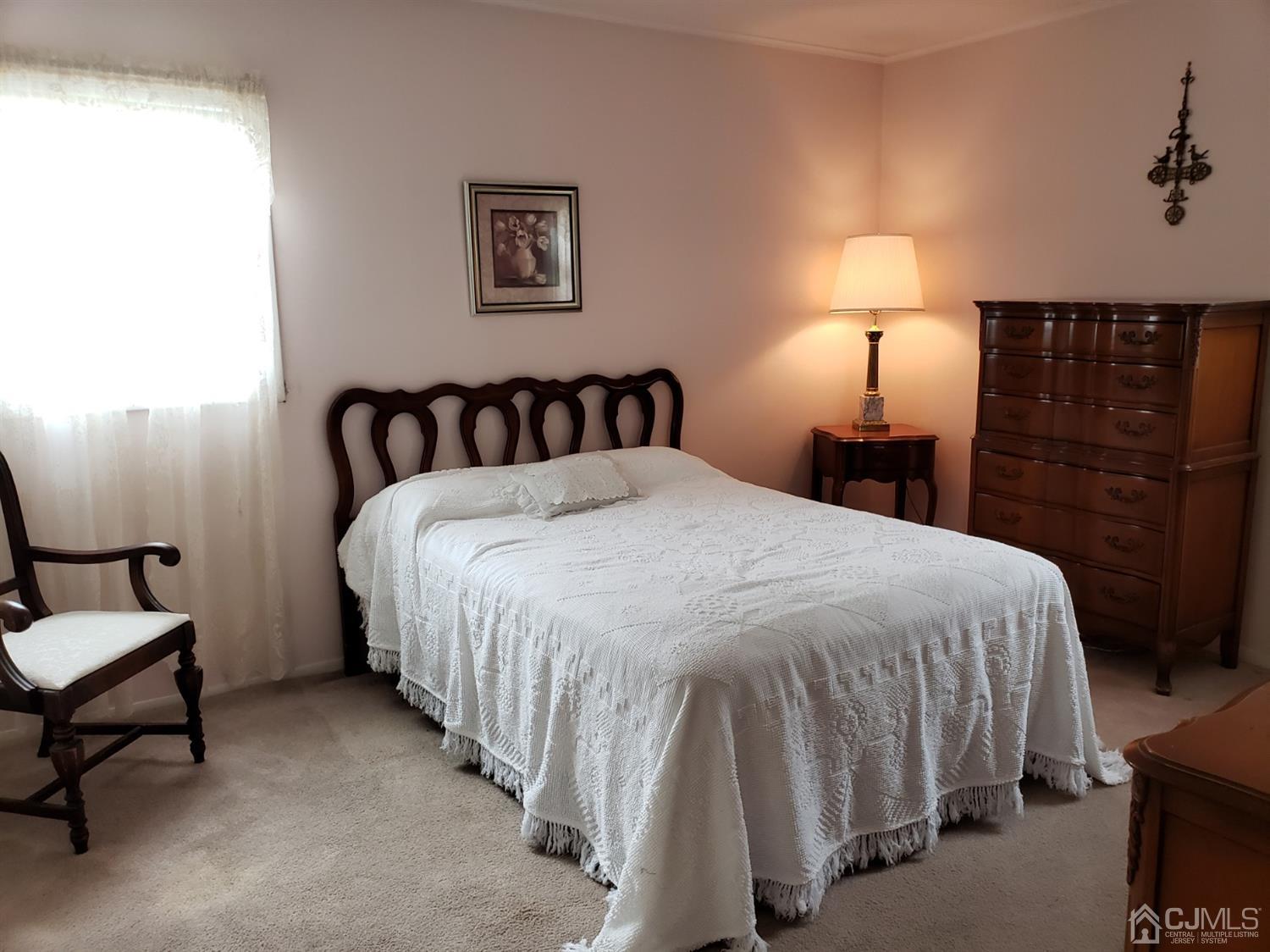 33 Tunison Road New Brunswick, NJ 08901 - Photo 10 of 27 a bedroom with a bed and a lamp with the dresser
