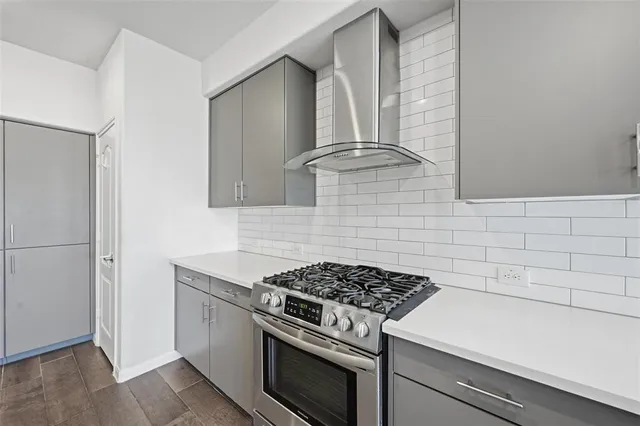 a kitchen with stainless steel appliances a sink and a refrigerator