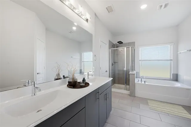 a bathroom with a tub sink and mirror