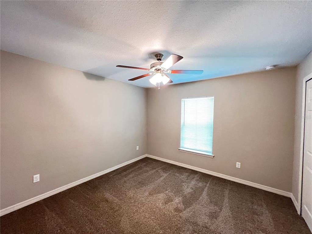 2427 Southwest 168th Loop Ocala, FL 34473 - Photo 12 of 21 wooden floor in an empty room with a window