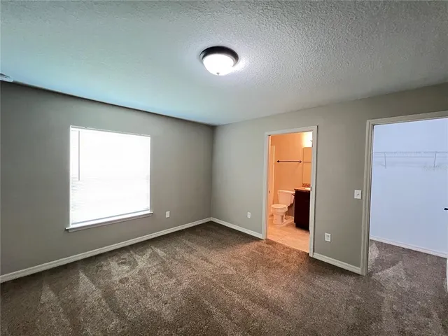 an empty room with a empty space and windows