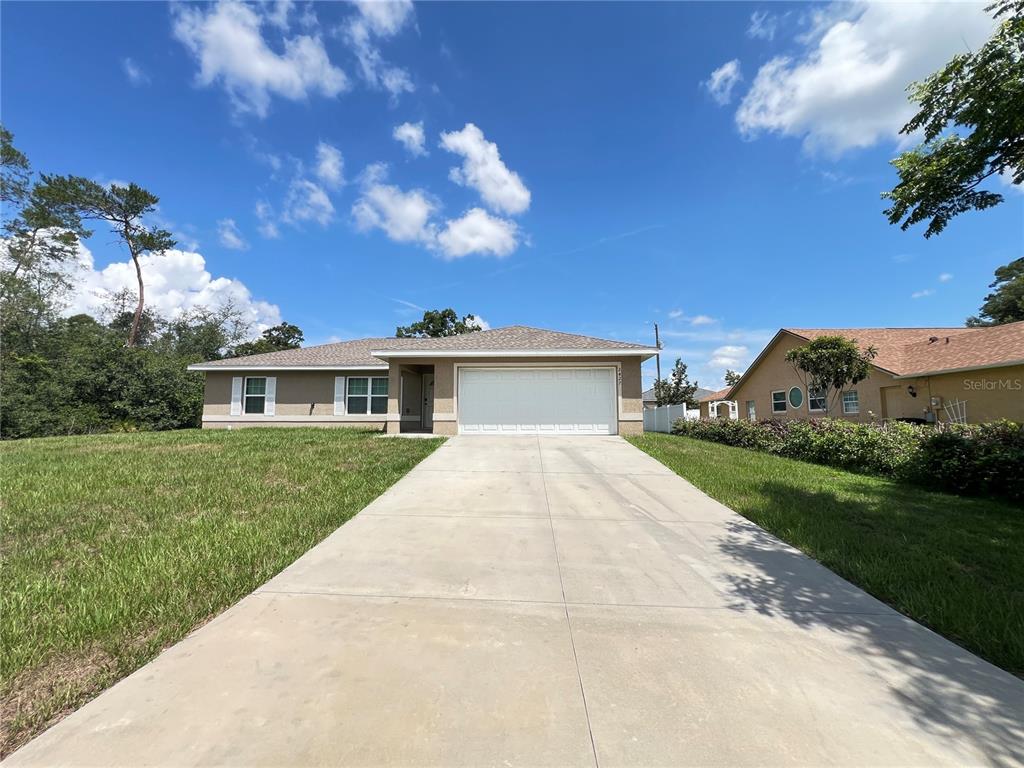 2427 Southwest 168th Loop Ocala, FL 34473 - Photo 2 of 21 a front view of a house with a yard
