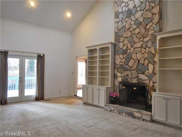 Den/Family/Great Room. Great Room has a stone fireplace flanked by built-ins & French doors leading to the deck.