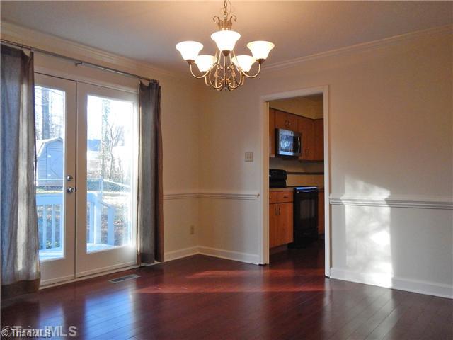 Dining Room. The Dining Room has hardwood floors, crown molding, a chair rail & French doors to the deck.