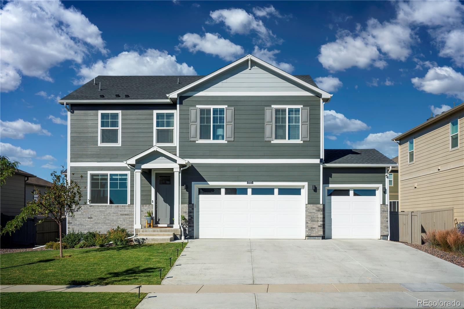 1521 Sun River Road Berthoud, CO 80513 - Photo 1 of 23 a front view of a house with a yard and garage