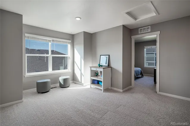 a bedroom with a bed and large window