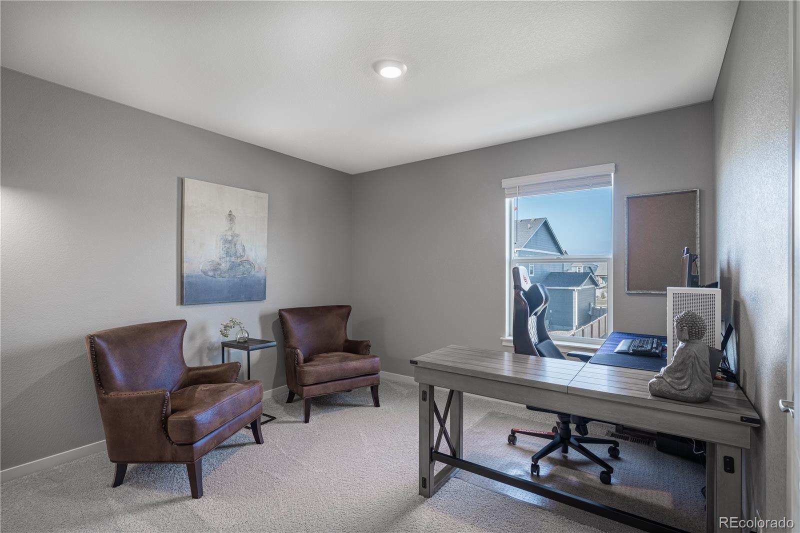 1521 Sun River Road Berthoud, CO 80513 - Photo 15 of 23 a room with a table chairs and a workspace