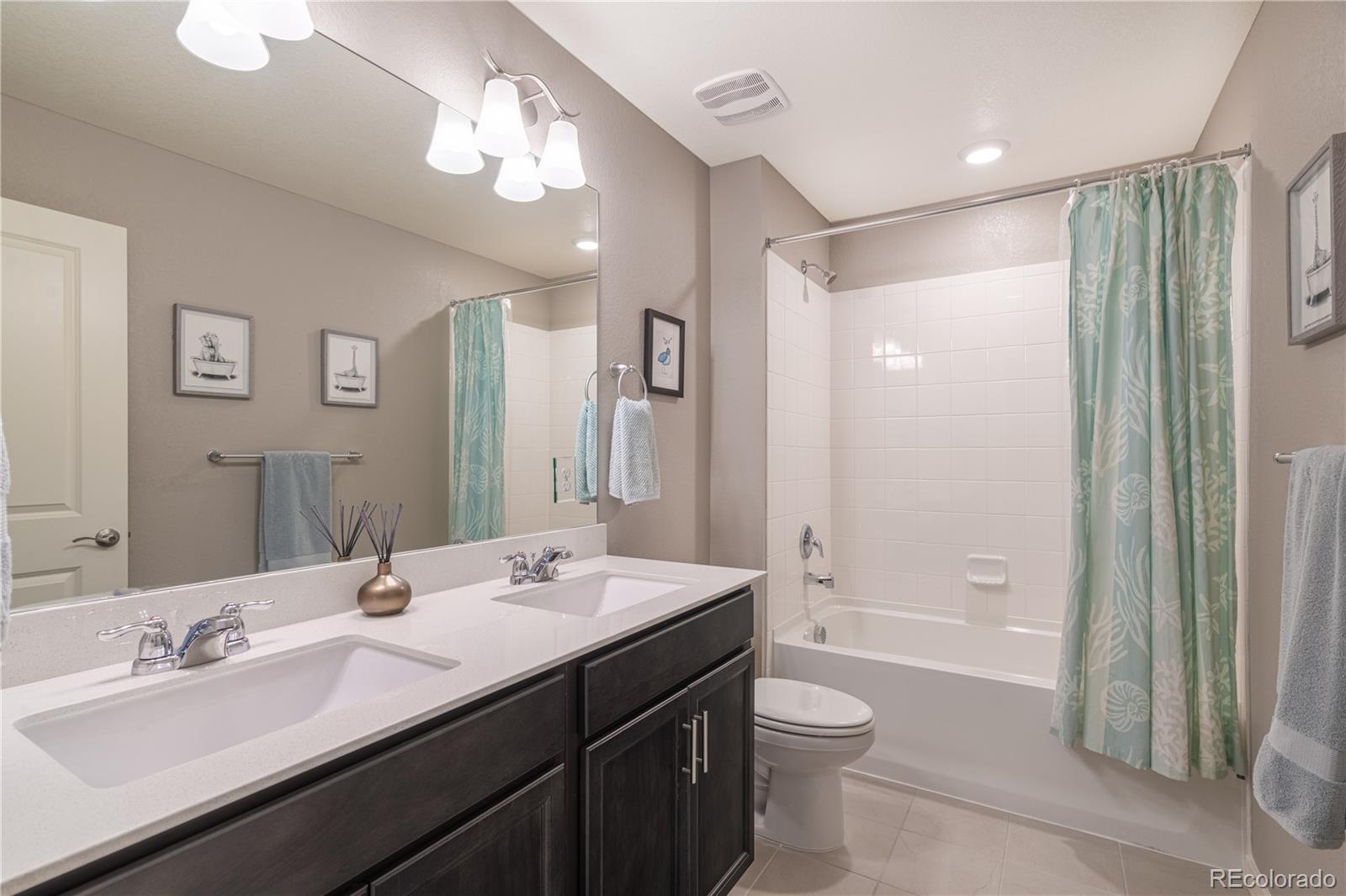 1521 Sun River Road Berthoud, CO 80513 - Photo 16 of 23 a bathroom with a double vanity sink toilet double vanity and shower