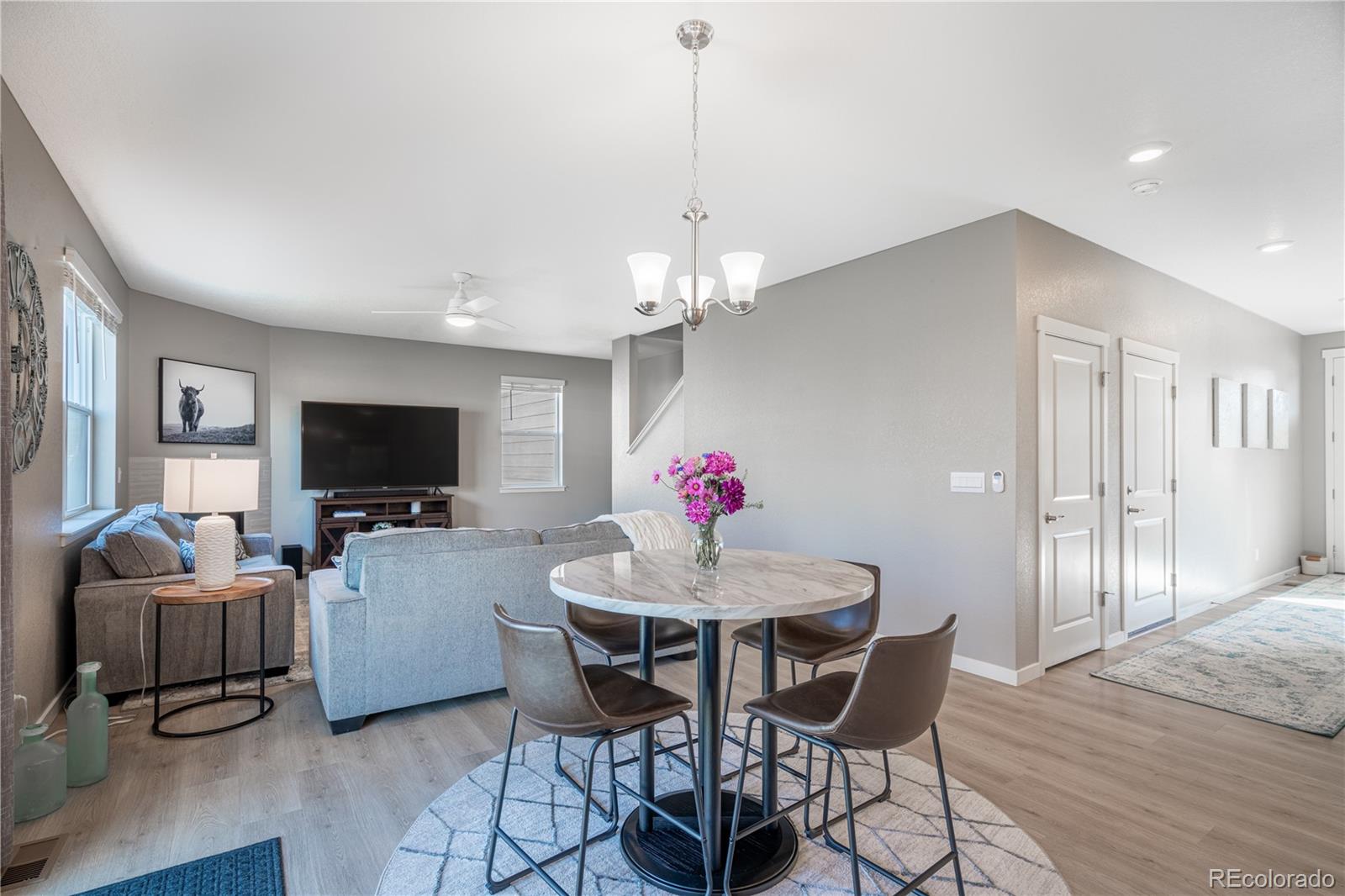 1521 Sun River Road Berthoud, CO 80513 - Photo 6 of 23 a dining room with furniture a chandelier and wooden floor