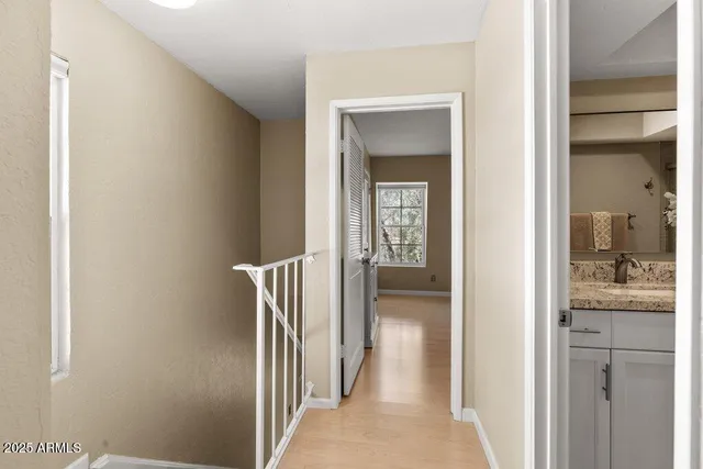 a view of a hallway with a livingroom and a bathroom