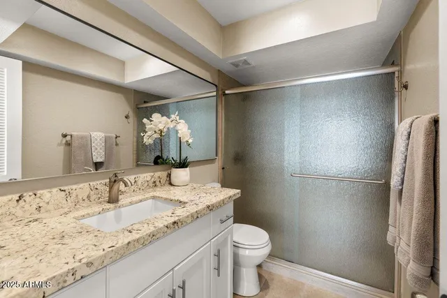 a bathroom with a shower and a sink