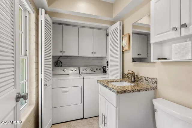 a view of a house with a tree and wooden fence