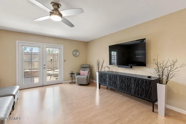 a living room with furniture and kitchen view