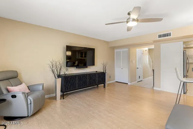 a kitchen with a dining table chairs sink and cabinets