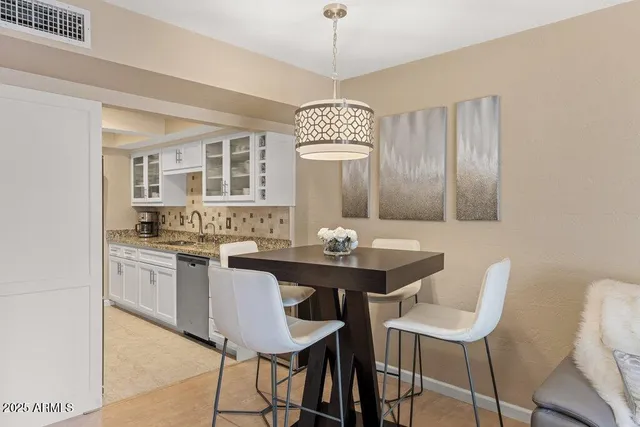 a kitchen with granite countertop sink and cabinets