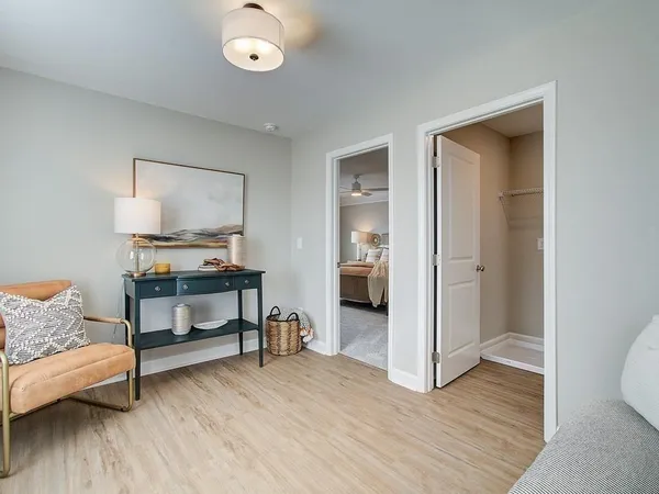 a bedroom with a bed and painting on the wall