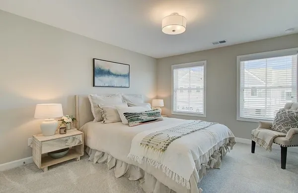 a bedroom with a bed and a chair