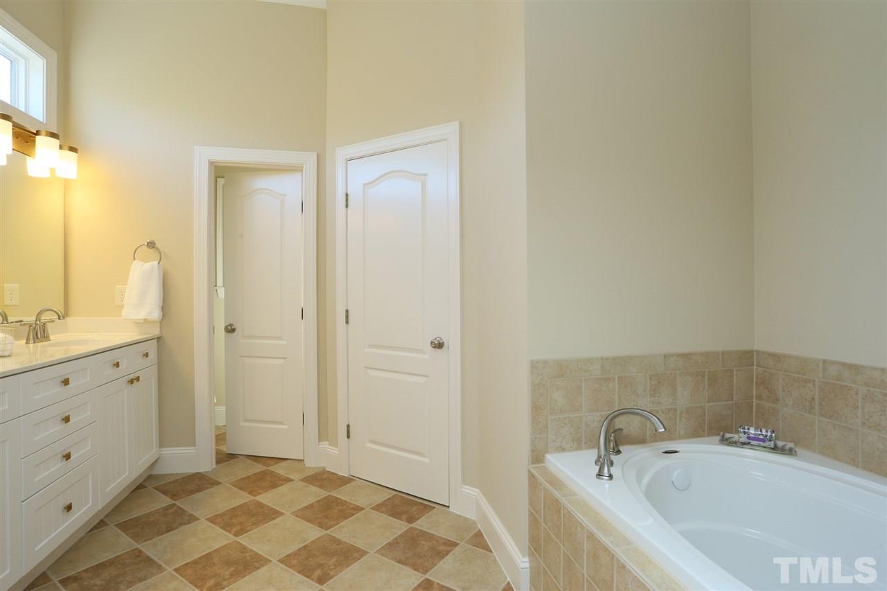 1164 Harp Street Raleigh, NC 27604 - Photo 17 of 25 a bathroom with a sink and a tub